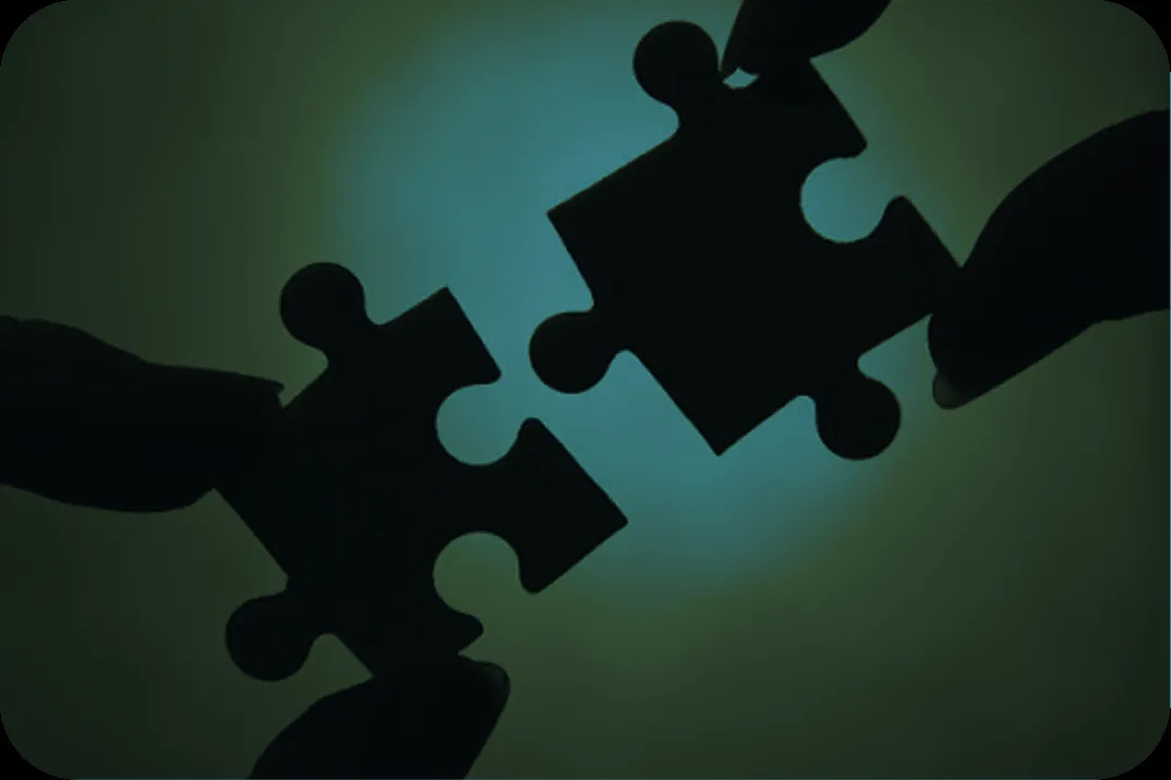 Two hands connecting puzzle pieces symbolizing modular thinking and strategic digital solutions